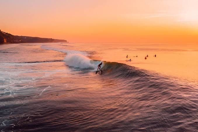 Surfer riding Medewi's main point